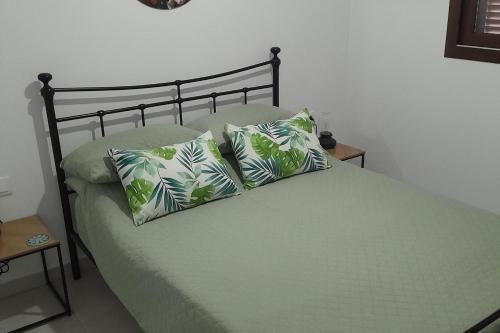 a bed with two pillows on it in a bedroom at Brand new Apartment in Mar de Pulpi in Pulpí