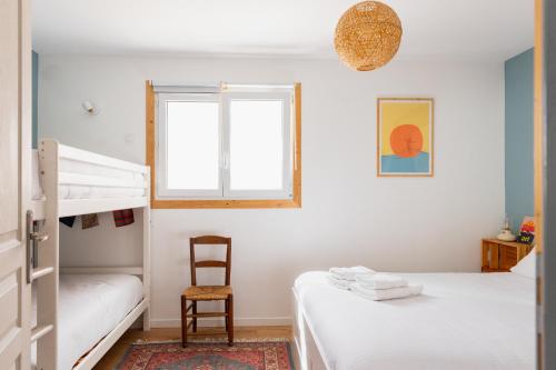 une chambre avec deux lits et une fenêtre dans l'établissement Côte et Rôve Maison mignon au bord de mer, à Plouhinec