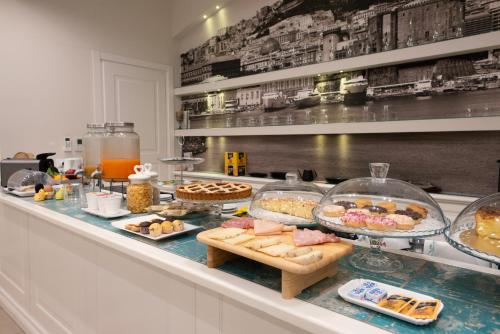 a buffet line with many different types of food at Certosa Suite in Naples