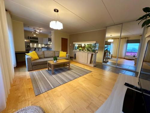 a living room with a couch and a table at City Marina Apartment with Seaview in Tallinn