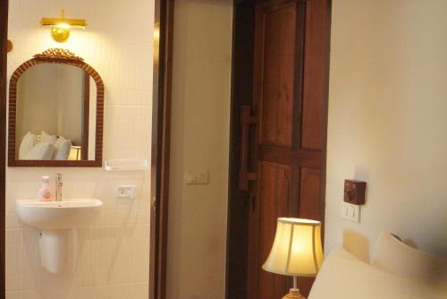 a bathroom with a sink and a mirror at Foresta Villa in Hang Dong
