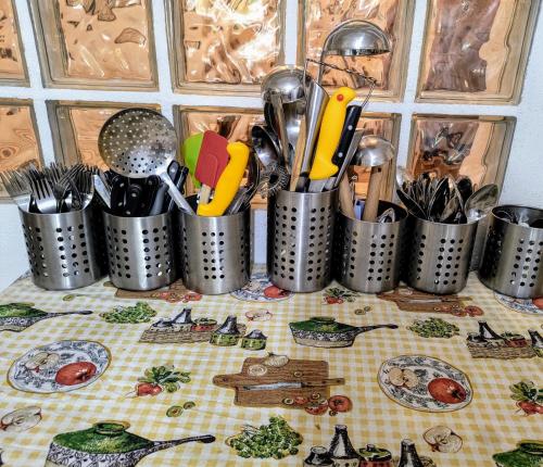a bunch of containers of utensils on a table at Poiana Sașilor - Valea Doftanei in Trăisteni