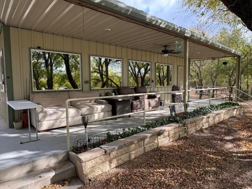 a screened in porch with couches and plants at Captains Cabin on Lake in Jacksboro