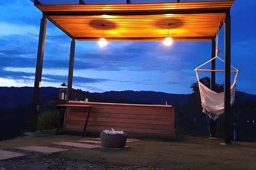 a gazebo with a hammock and a bucket at ketana - chalet turei g(4) in Sasaima
