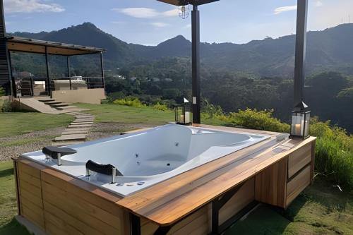 a jacuzzi tub with a view of the mountains at ketana - chalet turei g(4) in Sasaima