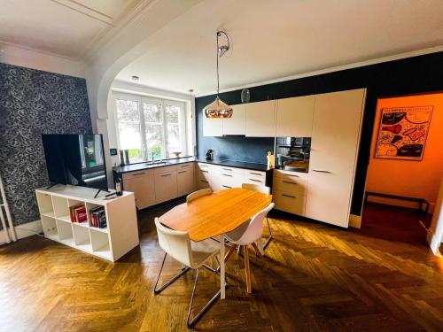 a kitchen with a wooden table and chairs in it at Cozy Apartment with Stunning Lakeview in Brienz