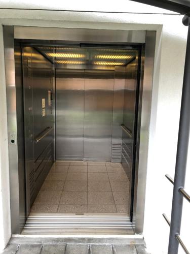 an elevator door in a building at Cozy Apartment with Stunning Lakeview in Brienz