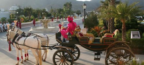 a group of people riding in a horse drawn carriage at Shiv Vilas Resort in Jaipur