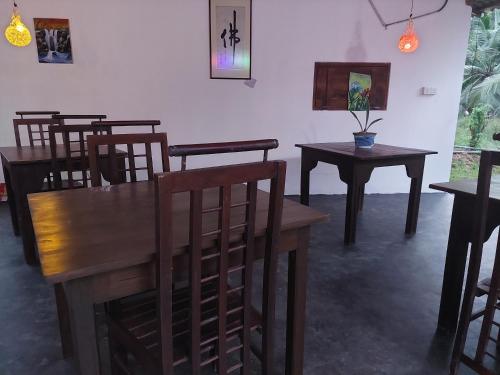a dining room with wooden tables and chairs at Sea Glow - Tangalle in Tangalle