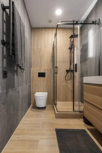 a bathroom with a shower and a toilet and a sink at Svencelės burė 10 in Svencelė