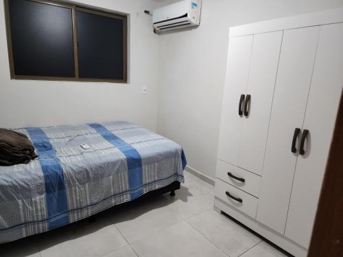 a bedroom with a bed and a dresser at Apartamento para suas férias ou trabalho in João Pessoa