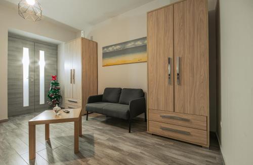 a living room with a couch and a christmas tree at Free Parking - Da Raf in Marano di Napoli