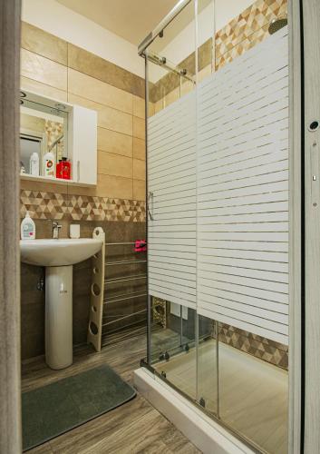 a bathroom with a glass shower and a sink at Free Parking - Da Raf in Marano di Napoli