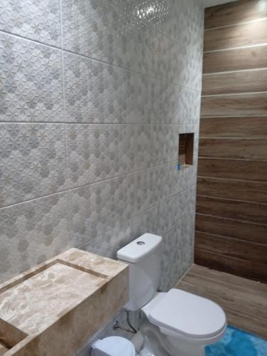 a bathroom with a toilet and a bath tub at Beach House Itamaracá in Itamaracá