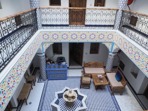 an overhead view of a staircase with a table and chairs at Palacio Del Sol in Chefchaouene