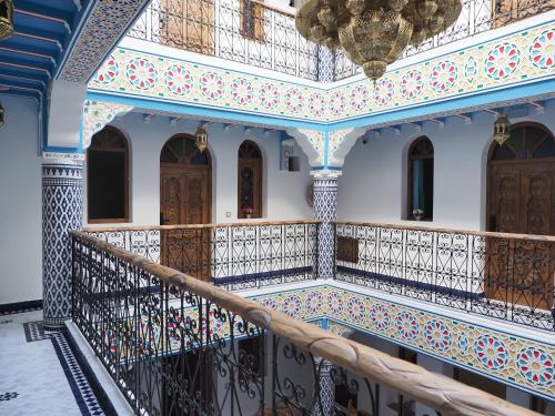 a balcony in a building with a chandelier at Palacio Del Sol in Chefchaouene