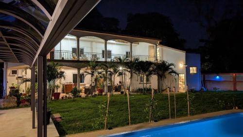 a large house with a pool in front of it at Maison des Sables - Turquoise in Port Louis