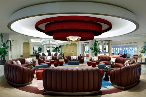 a lobby with leather furniture and a large ceiling at Hard Rock Hotel Marbella - Puerto Banús in Marbella