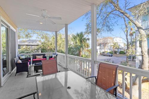 a porch with chairs and a ceiling fan at Tybee Tides 510A in Tybee Island