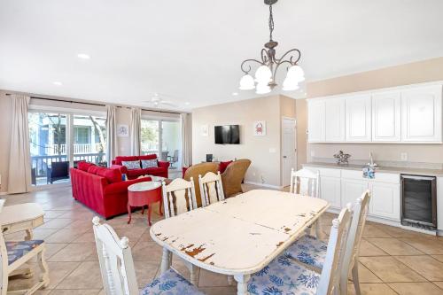 a living room with a table and a red couch at Tybee Tides 510A in Tybee Island