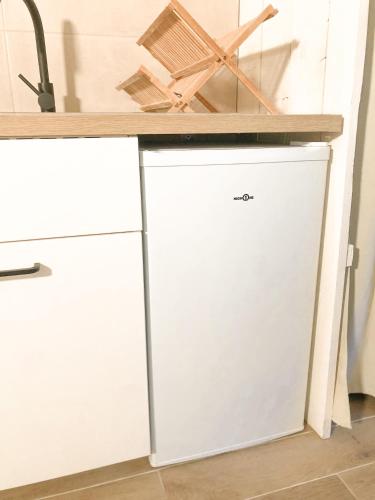 a white cabinet with a counter on top of it at Le studio du Coutach in Quissac