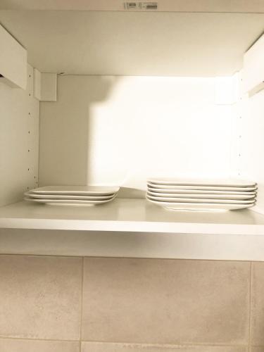 two stacks of plates sitting on a shelf in a kitchen at Le studio du Coutach in Quissac