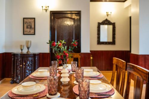 a dining room table with plates and dishes on it at Wizards Den-Harry Potter inspired 3BHK in Mashobra in Mashobra