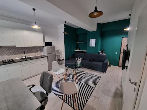 a living room with a couch and a table and chairs at Premier Luxury Lazar Residence by TOD Apartments in Iaşi
