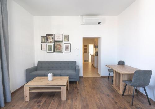 a living room with a couch and a table at New Favoriten - Serviced Apartments in Vienna