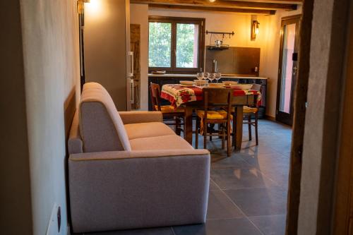 a kitchen and dining room with a table and chairs at Il Capriccio del Papa in Genga
