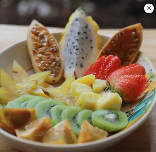 a bowl filled with fruit on a table at Visus Hotel Boutique & Spa in Pereira