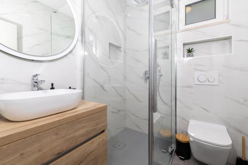 a white bathroom with a sink and a shower at Villa Vista Jelsa in Jelsa