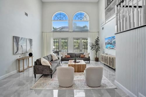 a living room with a couch and a table and chairs at Spacious Luxury Villa in Hollywood 6BR 5-Bath 5-Min Walk to Beach & Attractions in Hollywood