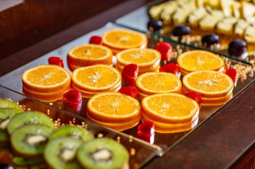 a bunch of fruit on a tray with oranges and strawberries at Hotel Argentina in Grado