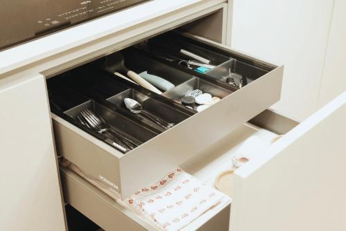 a drawer in a kitchen with dishes in it at Guli's Suite - Lusso e Comfort in Centro Storico in Naples