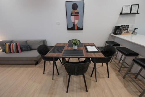 a dining room with a table and chairs and a couch at St Jo'Studio in Quebec City