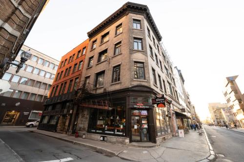 a tall brick building on the corner of a street at St Jo'Studio in Quebec City