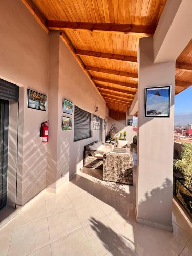 a patio with a wooden ceiling at La Maison Attawba in Beni Mellal