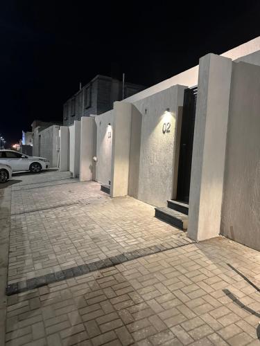 a building with a car parked in front of it at night at Nomad suites in Al Madinah