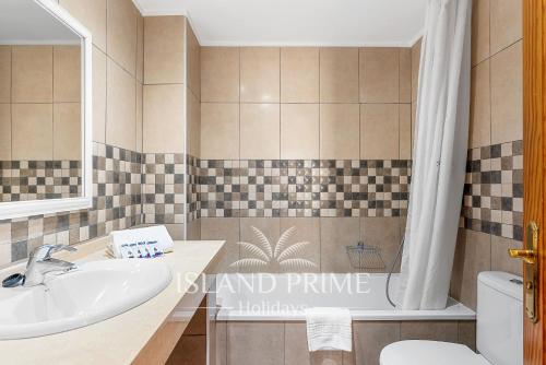 a bathroom with a sink and a toilet and a tub at South Facing Garden Holiday in Heated Pool Complex FC715 - 2xSt in San Miguel de Abona