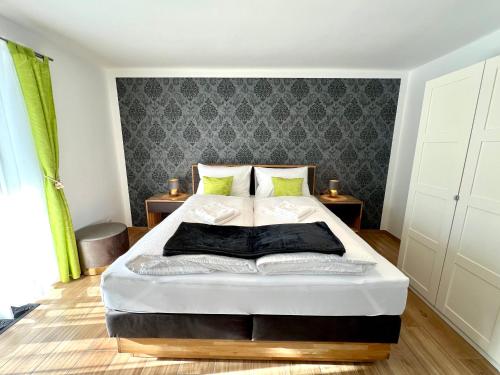 a bedroom with a large bed in a room at Apartments Sunnseitn by Gerrit & Herfried in Krumpendorf am Wörthersee