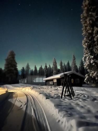 a snow covered road in front of a building at Villa Moinalahti in Sirkkakoski