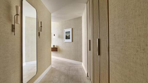 a hallway of a home with a large mirror at Four Seasons Hotel and Residences Fort Lauderdale in Fort Lauderdale