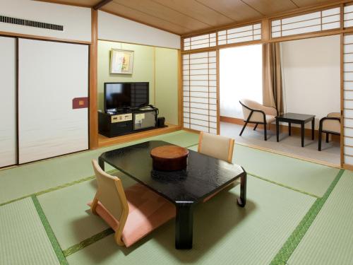 a living room filled with furniture and a tv at Hotel Mielparque Tokyo in Tokyo