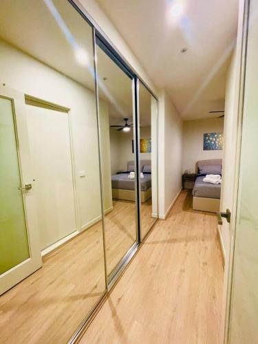 a room with sliding glass doors and a bedroom at Melbourne CBD Southern Cross Collins St Skyline View Balcony in Melbourne