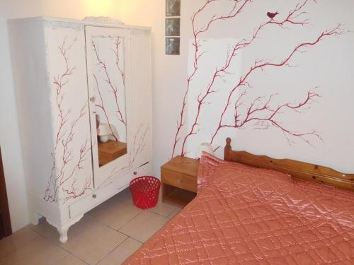 a bedroom with a bed and a mirror at Saronic Citadel Seaside villa in Salamís