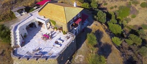 an overhead view of a large house with a yellow roof at Saronic Citadel Seaside villa in Salamís