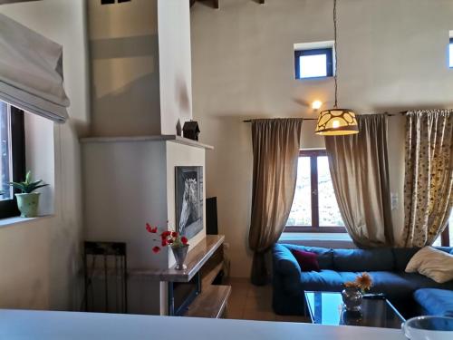 a living room with a blue couch in a room at Saronic Citadel Seaside villa in Salamís
