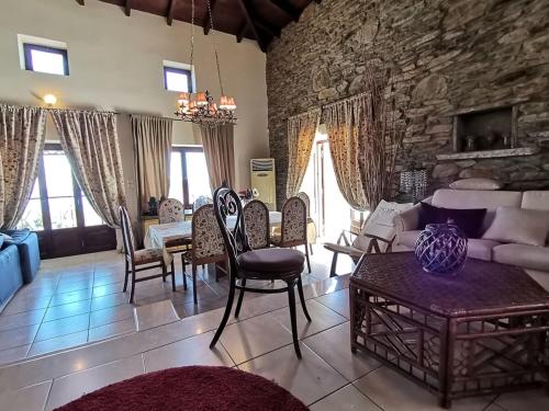 a living room with a stone wall at Saronic Citadel Seaside villa in Salamís