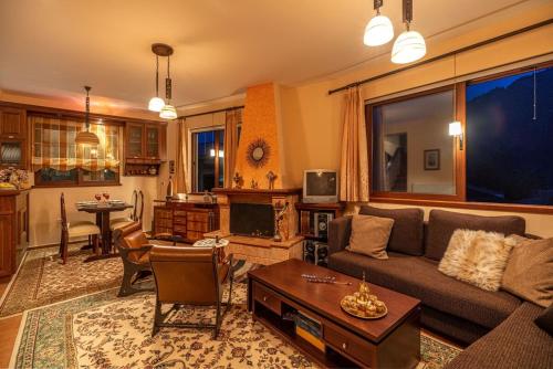 a living room with a couch and a table at Villa Kleino - 30 min from Meteora in Kalabaka